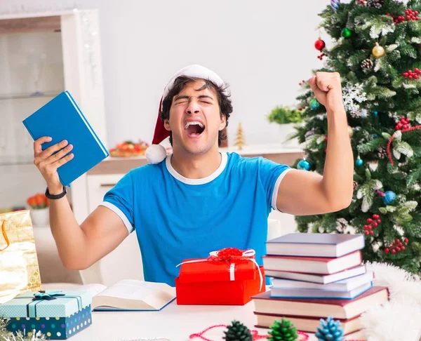 Young student with book at Christmas eve — Stock Photo, Image