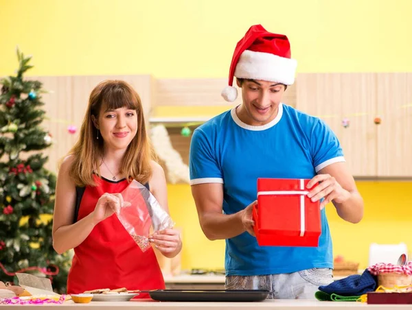 Young couple celebrating Christmas in kitchen — Stock Photo, Image