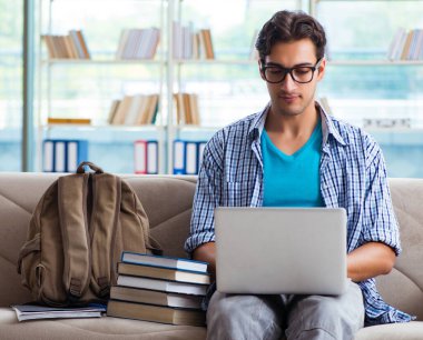 Bilgisayarlı beyaz öğrenci üniversite sınavlarına hazırlanıyor.