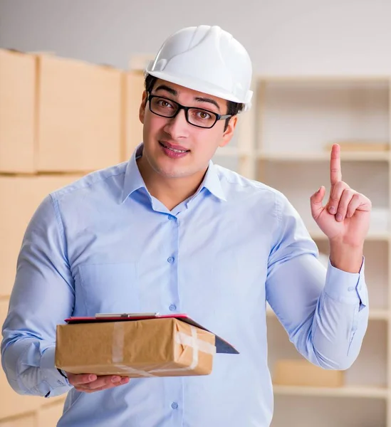 Young worker in the postal office dealing with parcels — Stock Photo, Image