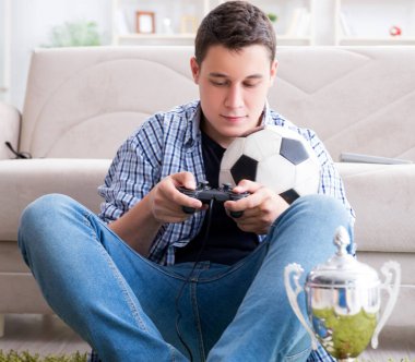 Genç adam evde bilgisayar oyunu oynuyor.