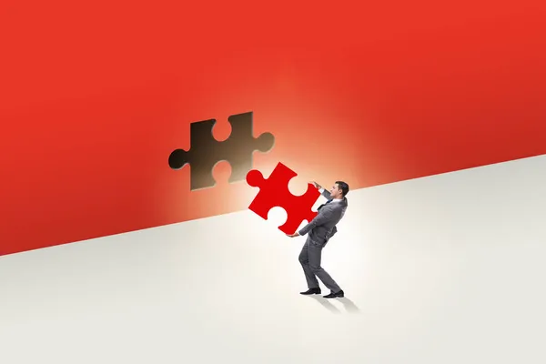 Businessman putting missing jigsaw puzzle piece — Stock Photo, Image