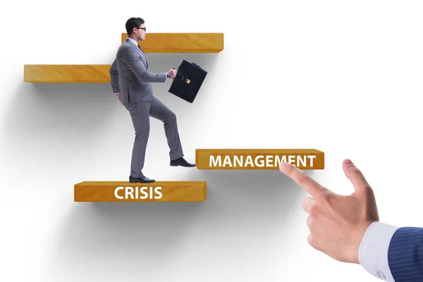 Crisis management concept with climbing businessman — Stock Photo, Image