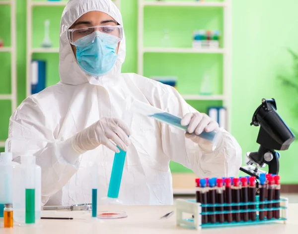 Laboratuvarda yeni bir deney üzerinde çalışan kimyager.