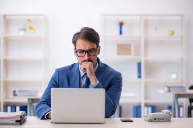 Ofiste çalışan genç bir erkek.