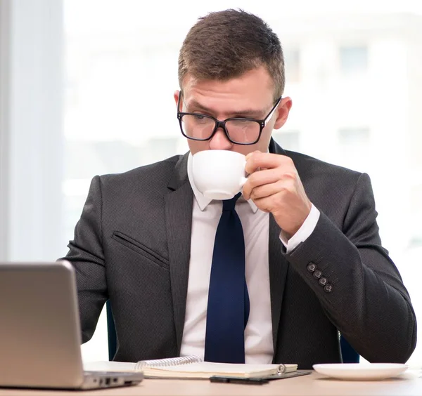 Jovem empresário bebendo chá no escritório — Fotografia de Stock