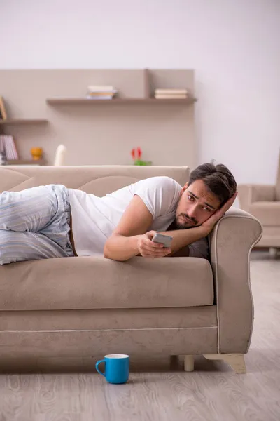 Young male student sitting at home during pandemic — Stock Photo, Image