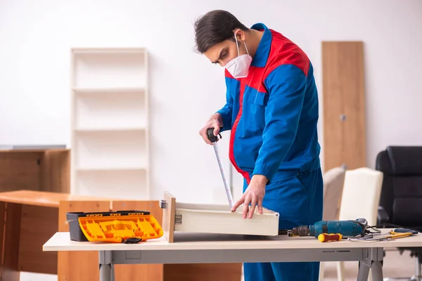 Young male carpenter working in the office during pandemic — Stock Photo, Image