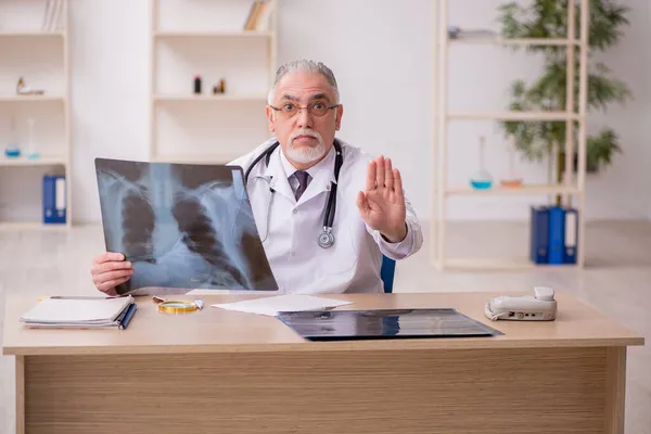 Vecchio medico radiologo maschile che lavora in clinica durante pandemi — Foto Stock