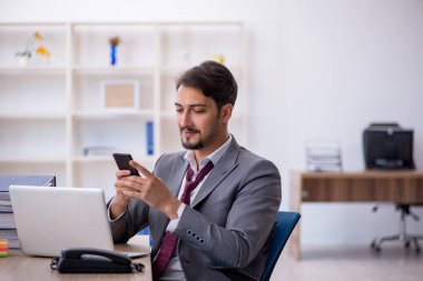 Ofiste çalışan genç bir erkek.