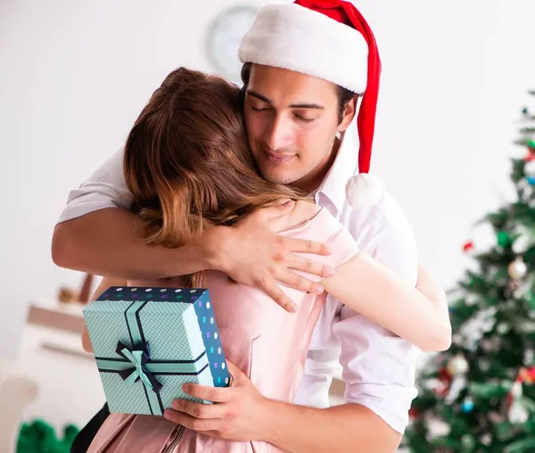 Jovem casal celebrando o Natal em casa — Fotografia de Stock