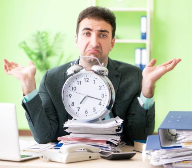 Ofiste otururken aşırı çalışmaktan kızgın bir iş adamı.