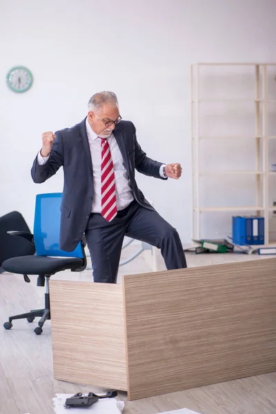 Old male employee working overtime in the office — Stock Photo, Image
