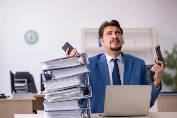 Young businessman employee unhappy with excessive work in the of — Stock Photo, Image