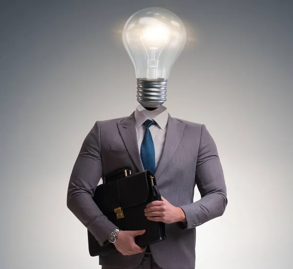Businessman in bright idea concept with lightbulb head — Stock Photo, Image