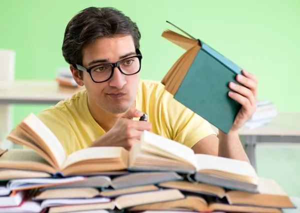 Student mit zu vielen Büchern zum Lesen vor der Prüfung — Stockfoto