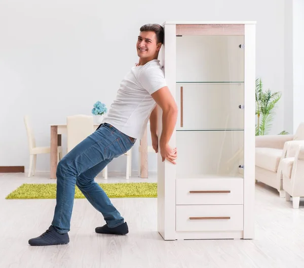 Man moving furniture at home — Stock Photo, Image