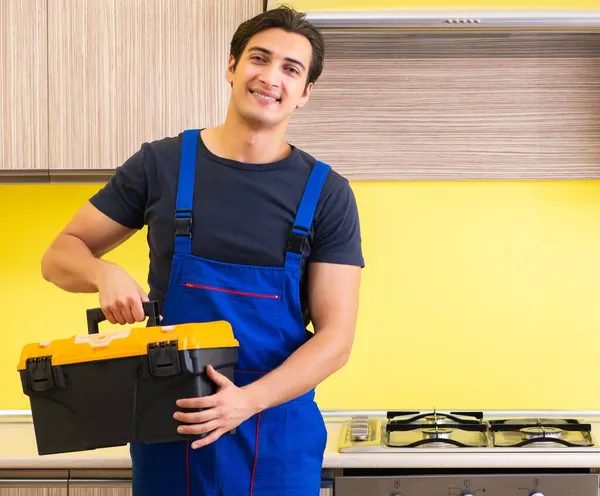 Joven contratista de servicio ensamblando muebles de cocina — Foto de Stock