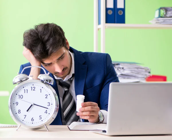 Бизнесмен недоволен чрезмерной работой, сидя в офисе — стоковое фото