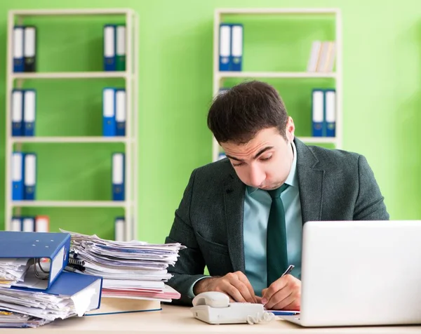 Businessman angry with excessive work sitting in the office — Stock Photo, Image