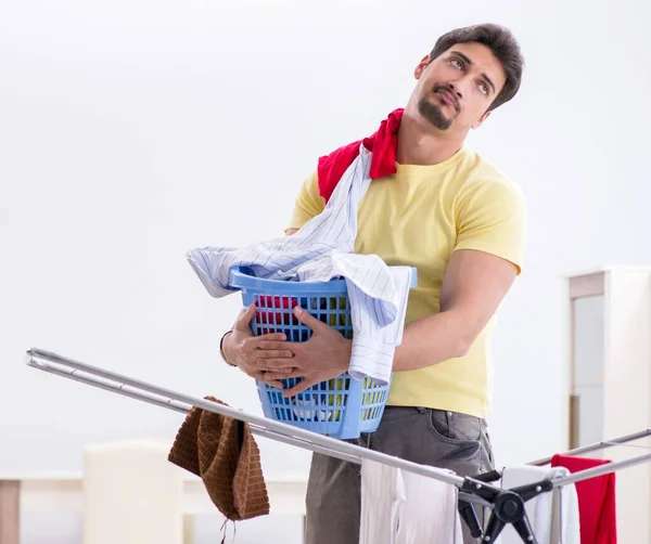 Handsome man husband doing laundering at home — Stock Photo, Image