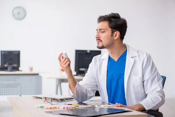 Ung manlig läkare som arbetar på kliniken — Stockfoto