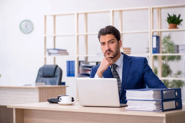 Young handsome employee working in the office — Stock Photo, Image