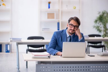 Ofiste çalışan genç bir erkek.