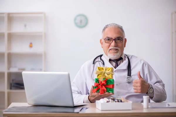 Yaşlı erkek doktor hastanede Noel 'i kutluyor. — Stok fotoğraf