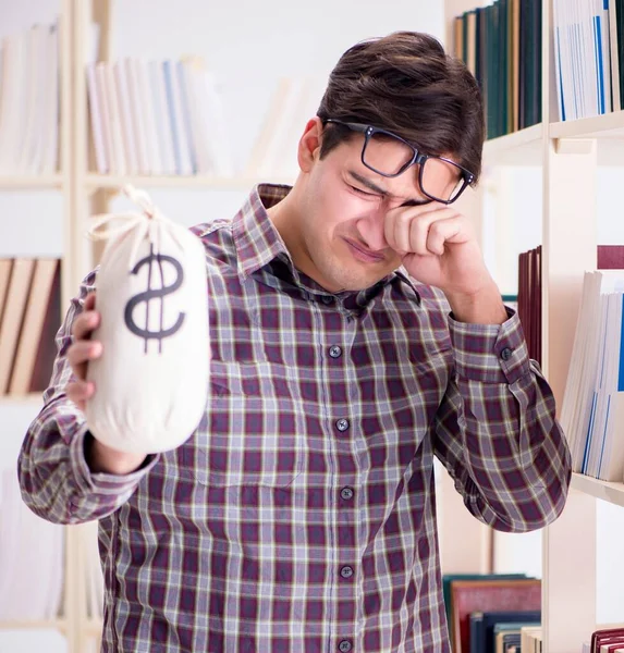 Young student in expensive textbooks concept — Stock Photo, Image