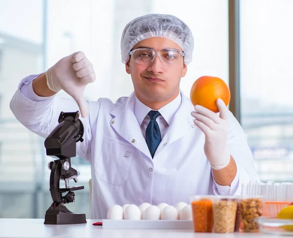 Nutrition expert testing food products in lab Royalty Free Stock Images