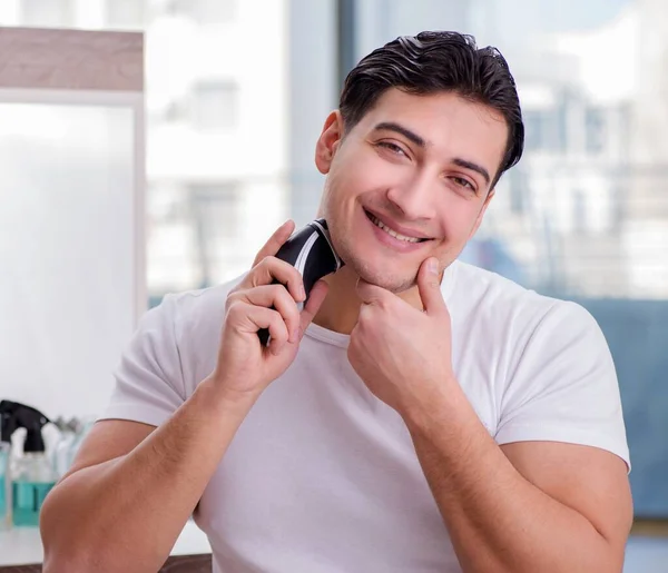 Young handsome man shaving in the morning — Stock Photo, Image