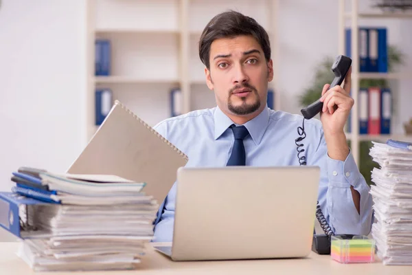 Jeune employé masculin et trop de travail au bureau — Photo