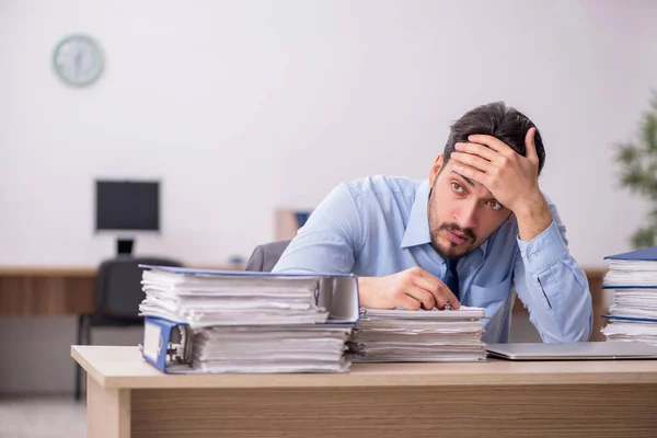 Junge männliche Mitarbeiter und zu viel Arbeit im Büro — Stockfoto