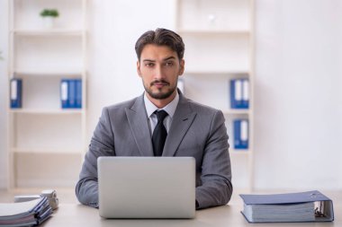 Ofiste çalışan genç bir erkek.