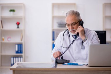 Teletıp konseptinde yaşlı bir doktor.