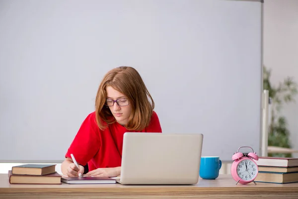 Young female student preparing for exams in the classroom — Stock Photo, Image