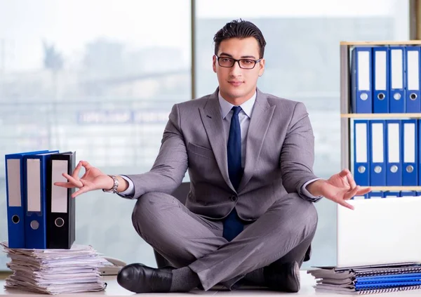 Businessman meditating in the office — Stock Photo, Image