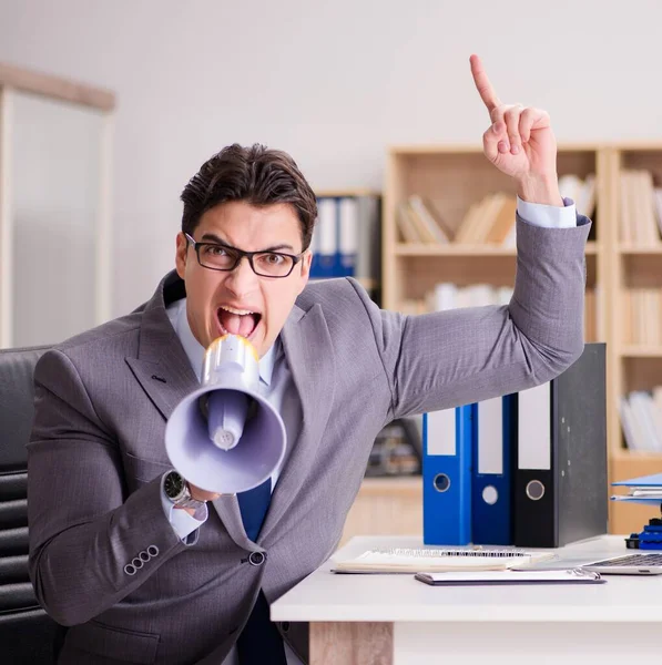 Businessman with loudspeaker in the office — Stock Photo, Image