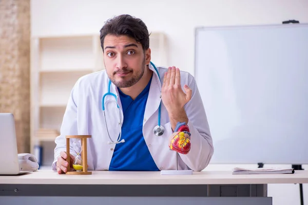 Giovane medico cardiologo maschile nel concetto di gestione del tempo — Foto Stock