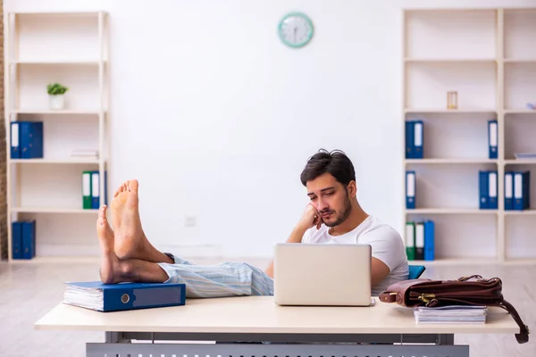 Ung manlig anställd kommer till jobbet direkt från sängen — Stockfoto