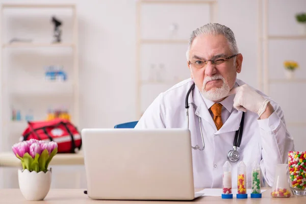 Oude mannelijke arts apotheker werkzaam in de kliniek — Stockfoto