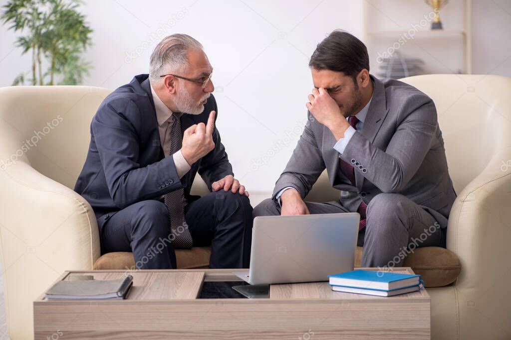 Two businessmen discussing project at workplace