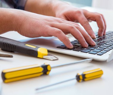 Bilgisayar tamircisi bilgisayar dizüstünü onarıyor