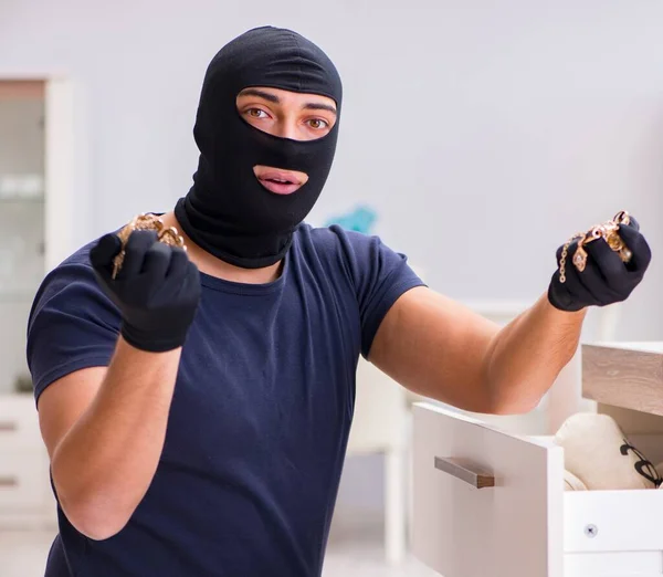 Robber wearing balaclava stealing valuable things — Stock Photo, Image