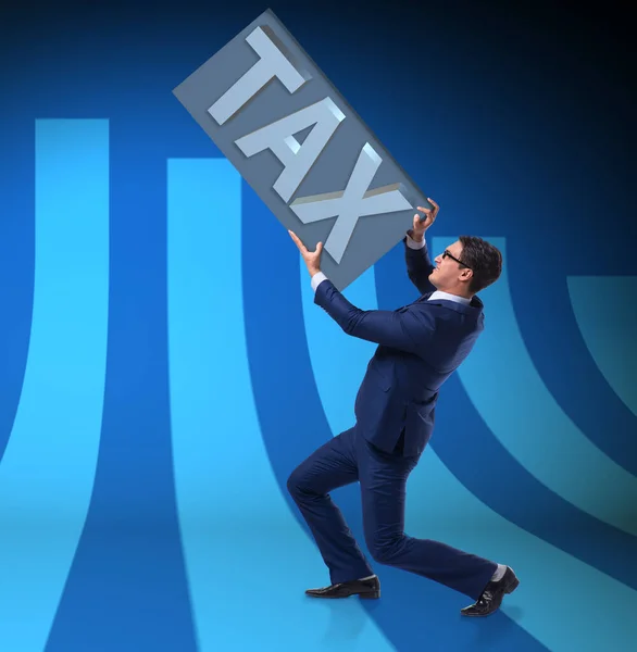 Businessman struggling with high taxes — Stock Photo, Image