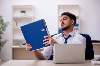 Ofiste çalışan genç bir erkek.