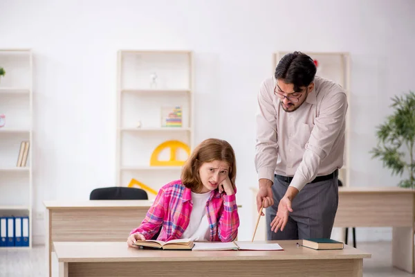 Young male teacher and redhead girl in the classroom — Stock Photo, Image