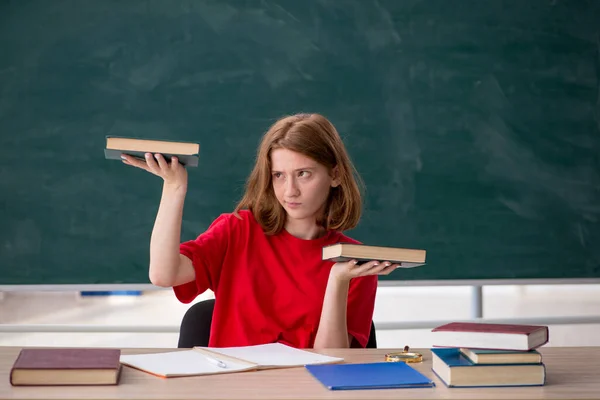 Jonge vrouwelijke student bereidt zich voor op examens in de klas — Stockfoto