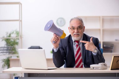 Kızgın patron iş yerinde megafon tutuyor.